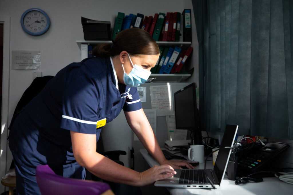 Nurse working on laptop.