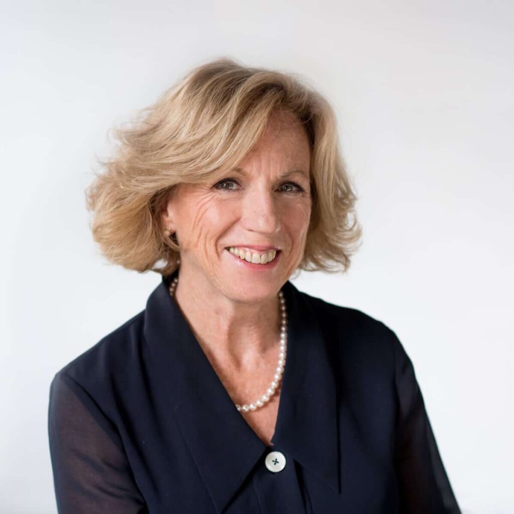 Headshot of a woman in black smiling.