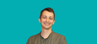 Image of cut out head and shoulders photo of a man with short dark hair wearing a brown shirt and smiling.