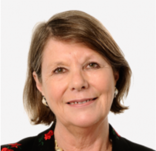 Head and shoulders of a woman with a bob hairstyle just above her shoulders, she is smiling.
