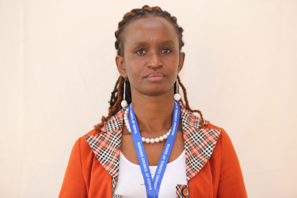 A head and shoulders shot of a woman staring straight at the camera