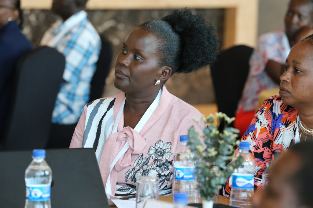 woman sitting at a table looking off to the left.