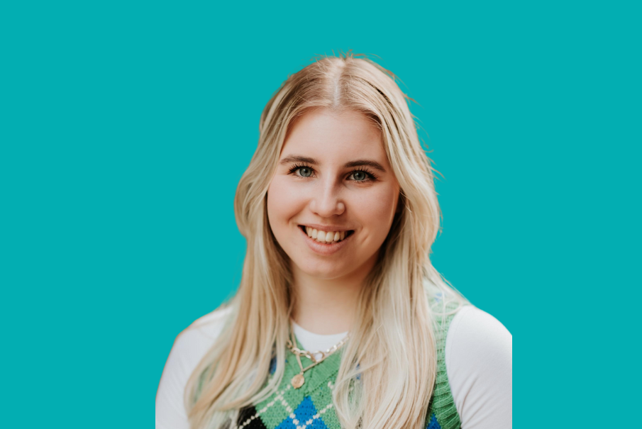 Head and shoulders image of a smiling woman, she has long blonde hair.